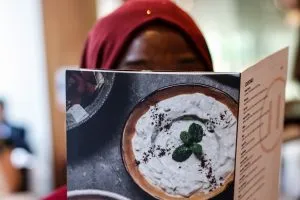 A photo of a woman looking at a menu