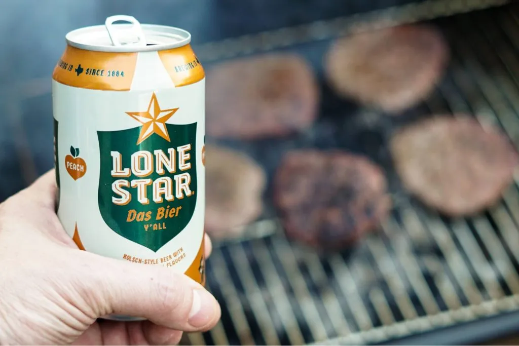 A photo of a hand holding Lone Star beer.