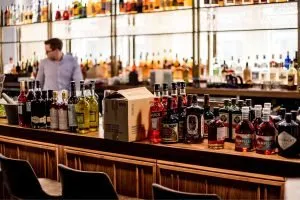 A photo of liquor bottles on a bar.
